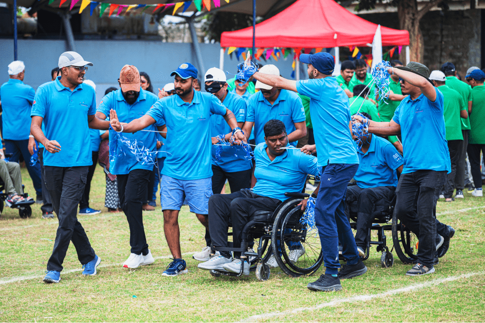 Inclusive team-building activity with standing and wheelchair participants.